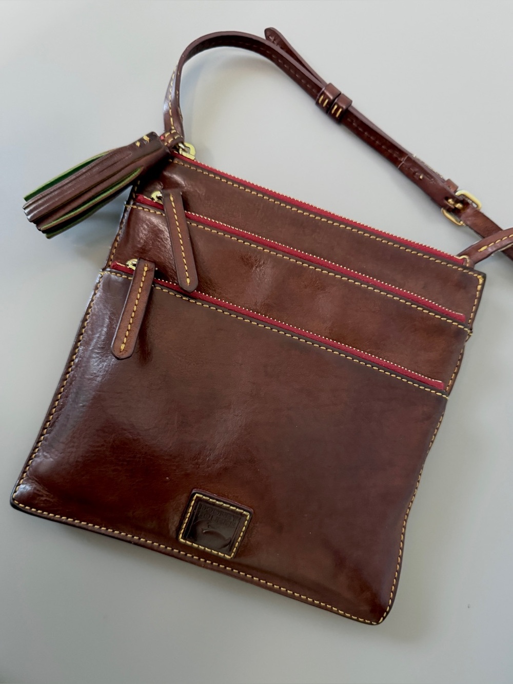 Dooney & Bourke Florentine leather triple zip crossbody bag in a chestnut brown - Picture 2 of 9